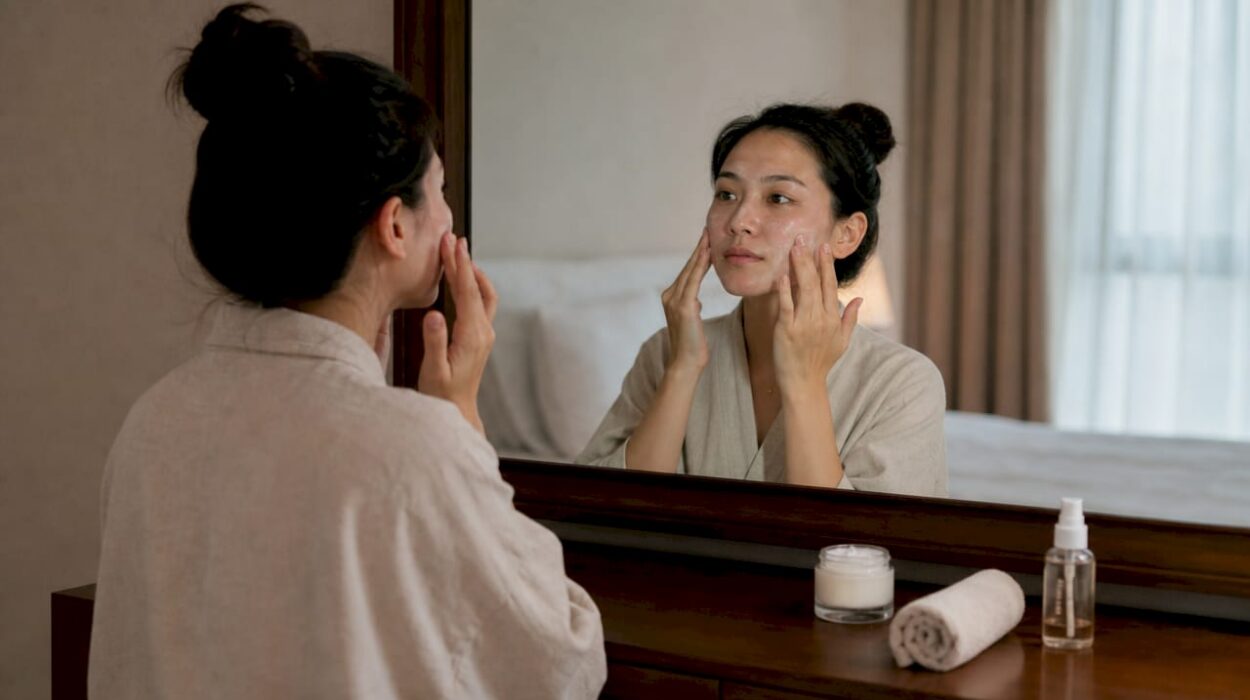 Woman applying skincare cream for rosacea