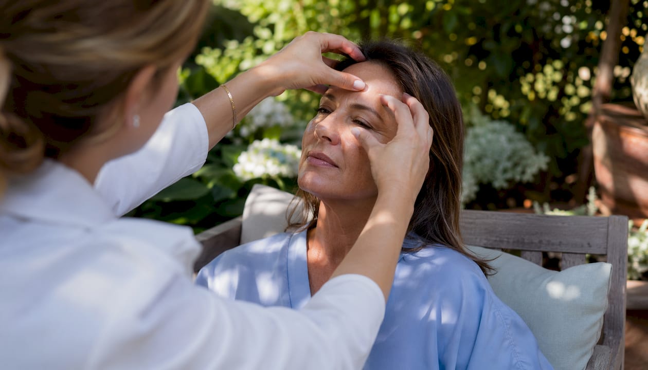 Clinician assessing patient's forehead after Botox
