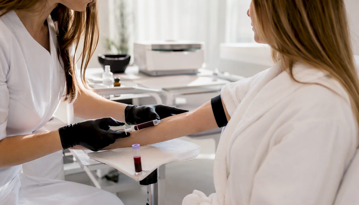Clinician drawing blood for PRP preparation