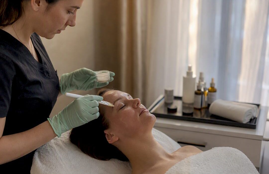 Clinician applying chemical peel to cheek