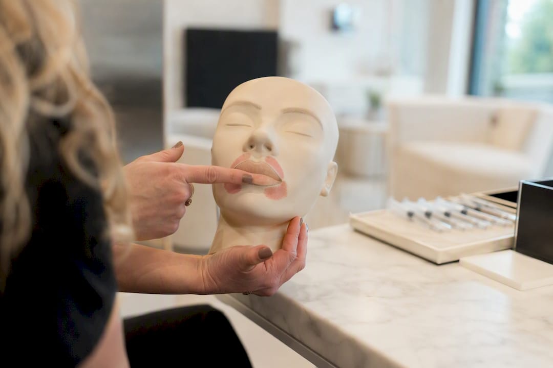 Clinician demonstrating swelling timeline on facial mold
