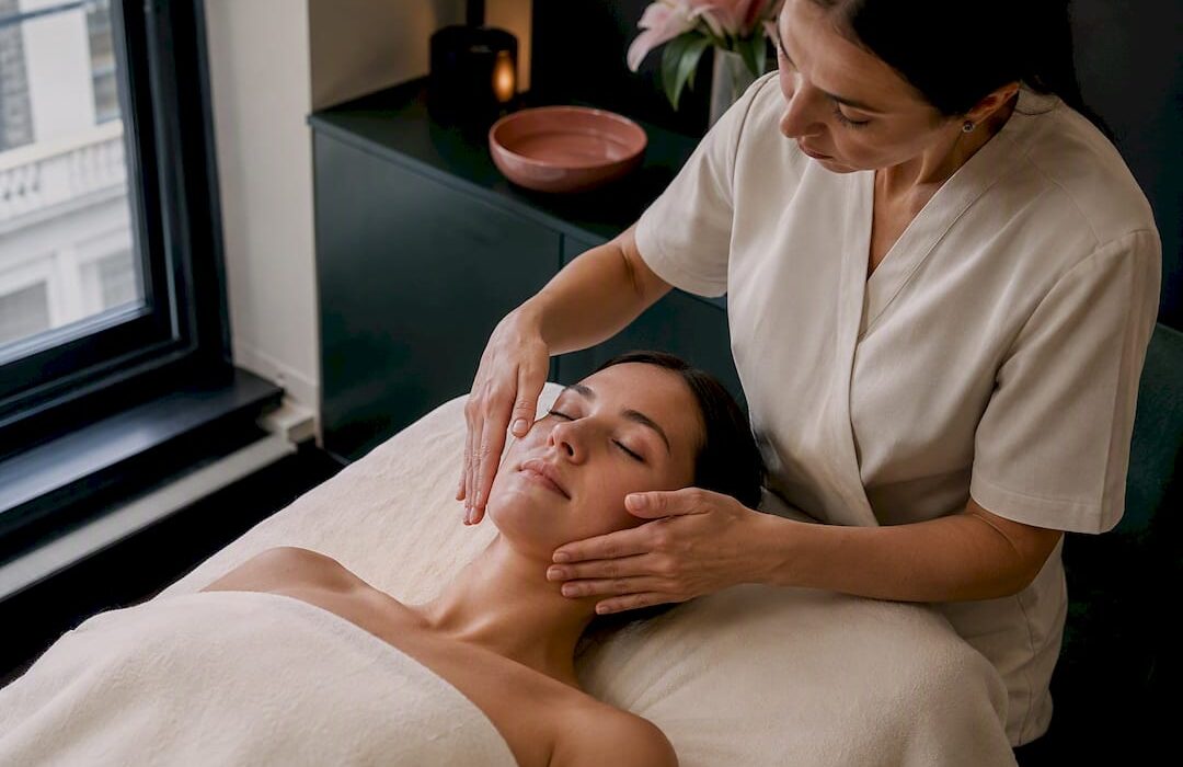 Therapist performing gentle facial lymphatic drainage
