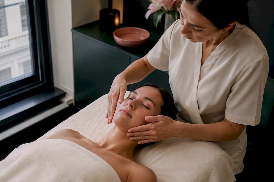 Therapist performing gentle facial lymphatic drainage