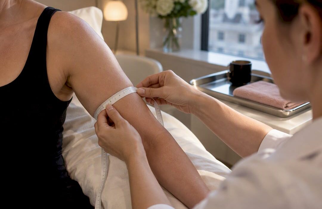 Clinician measuring adult upper arm circumference